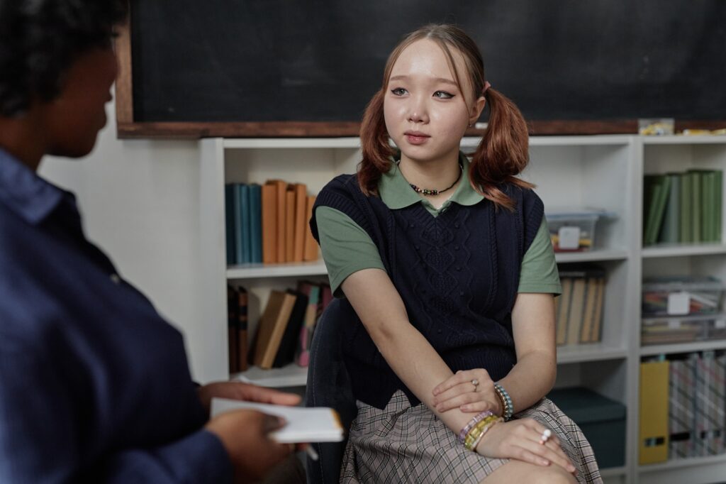 Asian Teen Girl Talking to Therapist in Counselling Session
